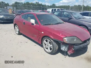 2006 Hyundai Tiburon GT z VIN KMHHN65F86U188431, wystawiony jako IAAI lot #41808475 z przebiegiem 208 879 mil mil oraz . Historia ofert i sprzedaży dostępna na DreamBid. Obrazek 1.