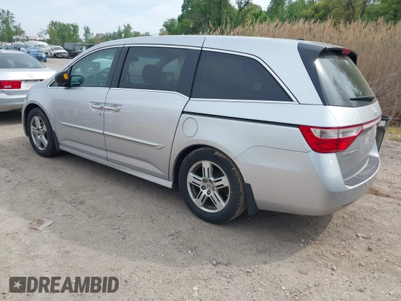 2012 Honda Odyssey Touring with VIN 5FNRL5H92CB055473, listed as a IAAI auction lot 42128601 with 163,901 mi miles. Bid and sale history available at carsss.com. Image 3.