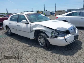 2001 Lincoln Continental with VIN 1LN8M82W11Y694879, listed as a IAAI auction lot 42313003 with Not provided miles and . Bid and sale history available at DreamBid. Image 1.