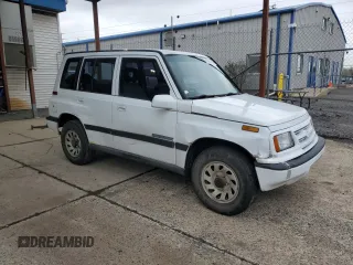 1996 Suzuki Sidekick JX z VIN 2S3TD03V7T6409487, wystawiony jako Copart lot #49977795 z przebiegiem 137 011 mil mil oraz Szkoda całkowita • Salvage title. Historia ofert i sprzedaży dostępna na DreamBid. Obrazek 4.