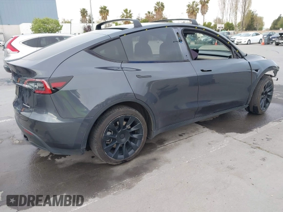 2021 Tesla Model Y Long Range with VIN 5YJYGAEE0MF223140, listed as a IAAI auction lot 42007701 with 55,308 mi miles. Bid and sale history available at carsss.com. Image 4.
