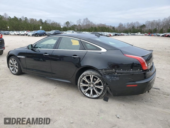 2015 Jaguar XJ with VIN SAJWA1CZ1F8V85402, listed as a Copart auction lot 86717734 with 201,249 mi miles and Salvage Title. Bid and sale history available at carsss.com. Image 2.