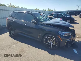 2020 BMW X5 M50i with VIN 5UXJU4C05LL228167, listed as a Copart auction lot 70390194 with Not Provided miles and Salvage Title. Bid and sale history available at DreamBid. Image 4.
