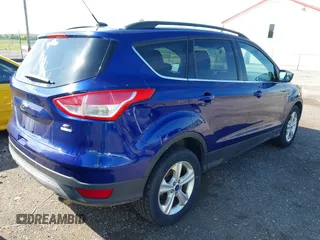 2014 Ford Escape SE with VIN 1FMCU9GX1EUB52373, listed as a IAAI auction lot 42163933 with 128,634 mi miles. Bid and sale history available at carsss.com. Image 4.