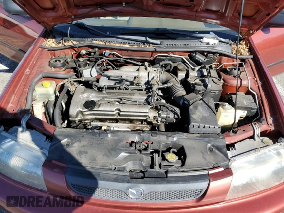 1998 Mazda Protege DX z VIN JM1BC1411W0198007, wystawiony jako Copart lot #46941185 z przebiegiem 101 696 mil mil oraz Szkoda całkowita • Salvage title. Historia ofert i sprzedaży dostępna na DreamBid. Obrazek 11.