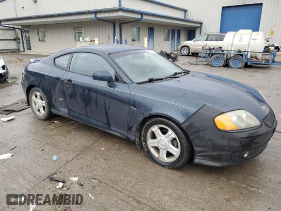 2003 Hyundai Tiburon GT z VIN KMHHN65F13U068658, wystawiony jako Copart lot #81799404 z przebiegiem 163 148 mil mil oraz Szkoda całkowita • Salvage title. Historia ofert i sprzedaży dostępna na DreamBid. Obrazek 4.