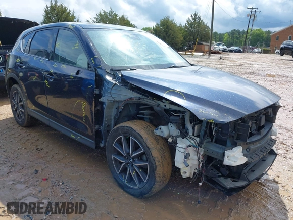 2018 Mazda CX-5 Grand Touring z VIN JM3KFADM8J1406007, wystawiony jako IAAI lot #42008567 z przebiegiem 110 661 mil mil oraz . Historia ofert i sprzedaży dostępna na DreamBid. Obrazek 1.