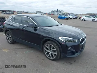 2020 BMW X2 xDrive28i with VIN WBXYJ1C02L5R71755, listed as a IAAI auction lot 41957012 with 69,997 mi miles. Bid and sale history available at carsss.com. Image 1.