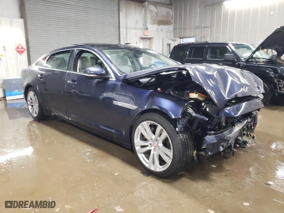 2014 Jaguar XJ with VIN SAJWJ2GD5E8V69562, listed as a Copart auction lot 87737195 with 100,525 mi miles and Salvage Title. Bid and sale history available at carsss.com. Image 4.