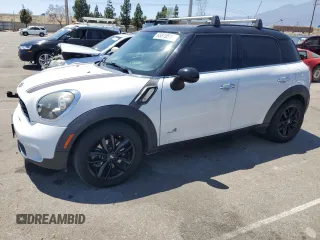2014 MINI Countryman S with VIN WMWZC5C56EWP37613, listed as a Copart auction lot 65810515 with 149,693 mi miles and Salvage title. Bid and sale history available at DreamBid. Image 1.