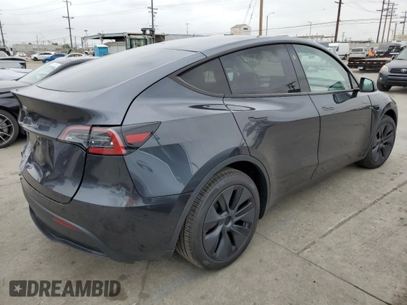 2025 Tesla Model Y Long Range with VIN 7SAYGDED4SF242721, listed as a Copart auction lot 56159955 with 7,131 mi miles and Salvage Title. Bid and sale history available at DreamBid. Image 3.