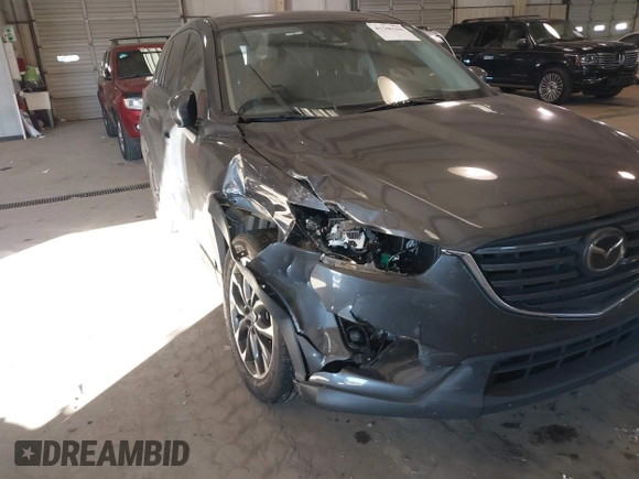 2016 Mazda CX-5 Grand Touring with VIN JM3KE2DYXG0846787, listed as a IAAI auction lot 41346364 with 113,553 mi miles. Bid and sale history available at carsss.com. Image 6.