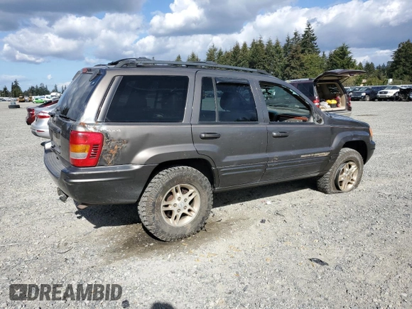 1999 Jeep Grand Cherokee Limited with VIN 1J4GW68S2XC677334, listed as a Copart auction lot 74152054 with 242,220 mi miles and Salvage Title. Bid and sale history available at carsss.com. Image 3.