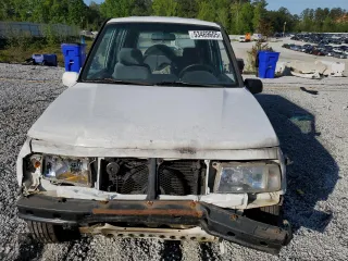 1997 Geo Tracker LSi z VIN 2CNBE1360V6927915, wystawiony jako Copart lot #53469605 z przebiegiem 119 413 mil mil oraz Szkody całkowita. Historia ofert i sprzedaży dostępna na DreamBid. Obrazek 5.