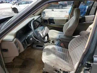 1995 Jeep Grand Cherokee Laredo with VIN 1J4FX58S8SC773884, listed as a Copart auction lot 56572555 with 424,126 mi miles and Salvage title. Bid and sale history available at DreamBid. Image 7.