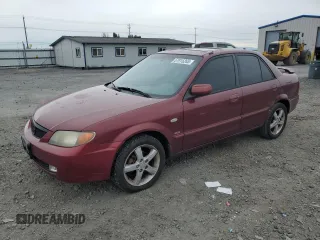 2002 Mazda Protege DX z VIN JM1BJ225320636991, wystawiony jako Copart lot #57915265 z przebiegiem 123 371 mil mil oraz Szkoda całkowita • Salvage title. Historia ofert i sprzedaży dostępna na DreamBid. Obrazek 1.