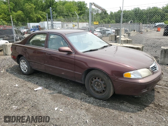 2000 Mazda 626 LX z VIN 1YVGF22C4Y5112874, wystawiony jako Copart lot #58952175 z przebiegiem 100 070 mil mil oraz Szkoda całkowita • Salvage title. Historia ofert i sprzedaży dostępna na DreamBid. Obrazek 4.