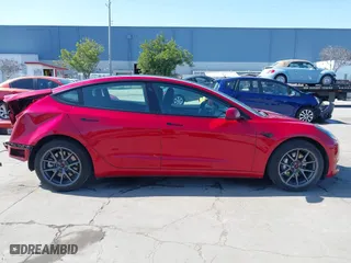 2021 Tesla Model 3 Standard Range Plus with VIN 5YJ3E1EA0MF099562, listed as a IAAI auction lot 41771323 with 26,087 mi miles. Bid and sale history available at carsss.com. Image 14.