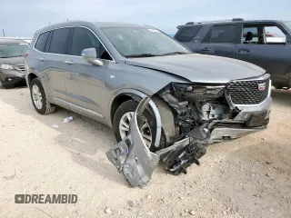 2024 Cadillac XT6 FWD Luxury with VIN 1GYKPAR41RZ700452, listed as a Copart auction lot 57675945 with 27,449 mi miles and Salvage title. Bid and sale history available at DreamBid. Image 4.