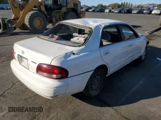 1999 Mazda 626 LX with VIN 1YVGF22D4X5882600, listed as a Copart auction lot 69031604 with 0 mi miles and Salvage Title. Bid and sale history available at carsss.com. Image 3.