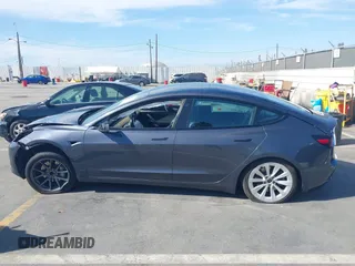 2022 Tesla Model 3 with VIN 5YJ3E1EA1NF142713, listed as a IAAI auction lot 42027630 with 112,557 mi miles. Bid and sale history available at carsss.com. Image 13.
