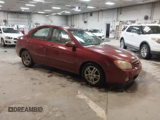 2004 Kia Spectra LX with VIN KNAFE122445012366, listed as a IAAI auction lot 41530178 with 120,115 mi miles. Bid and sale history available at carsss.com. Image 1.