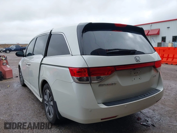 2014 Honda Odyssey Touring with VIN 5FNRL5H95EB059729, listed as a IAAI auction lot 42148110 with 135,304 mi miles and . Bid and sale history available at DreamBid. Image 3.