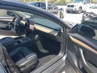 2023 Tesla Model 3 with VIN 5YJ3E1EAXPF575448, listed as a IAAI auction lot 42019288 with 33,859 mi miles and . Bid and sale history available at carsss.com. Image 5.