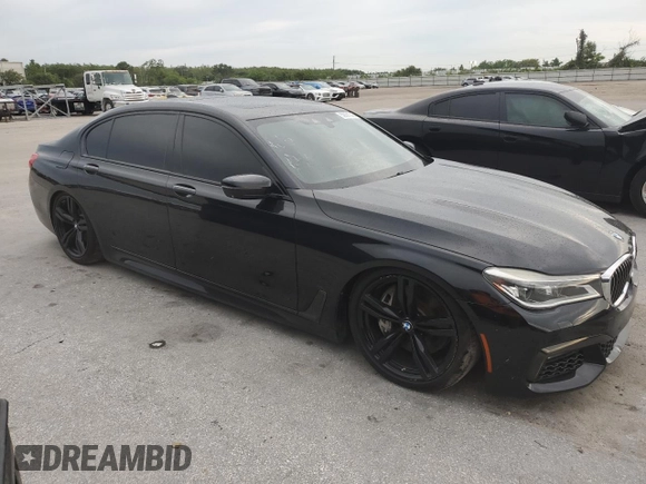 2016 BMW 7 Series 750i with VIN WBA7F0C56GGL99533, listed as a Copart auction lot 59091045 with 124,624 mi miles and Clean title. Bid and sale history available at DreamBid. Image 4.