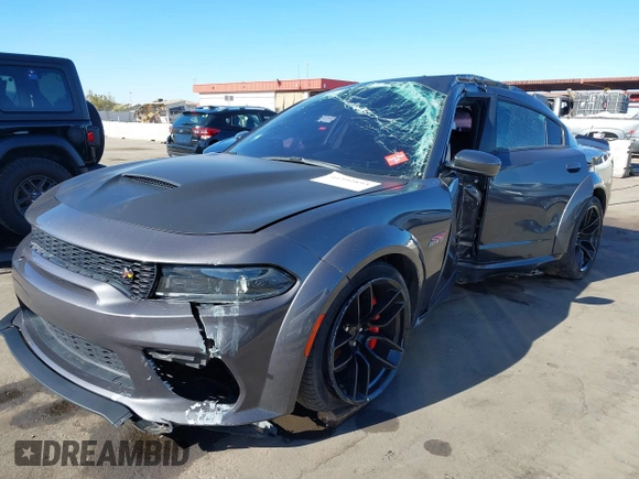 2022 Dodge Charger Scat Pack Widebody with VIN 2C3CDXGJ1NH204130, listed as a IAAI auction lot 41392893 with 9,515 mi miles and . Bid and sale history available at DreamBid. Image 2.