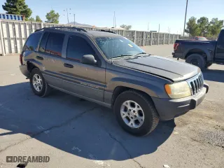 1999 Jeep Grand Cherokee Laredo with VIN 1J4GW58SXXC786179, listed as a Copart auction lot 79774564 with 272,192 mi miles and Salvage Title. Bid and sale history available at carsss.com. Image 4.