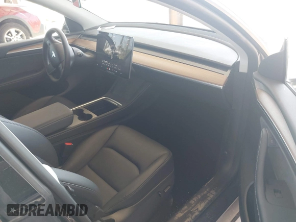 2023 Tesla Model Y Long Range with VIN 7SAYGAEE4PF906577, listed as a IAAI auction lot 42174987 with 13,260 mi miles and . Bid and sale history available at DreamBid. Image 5.