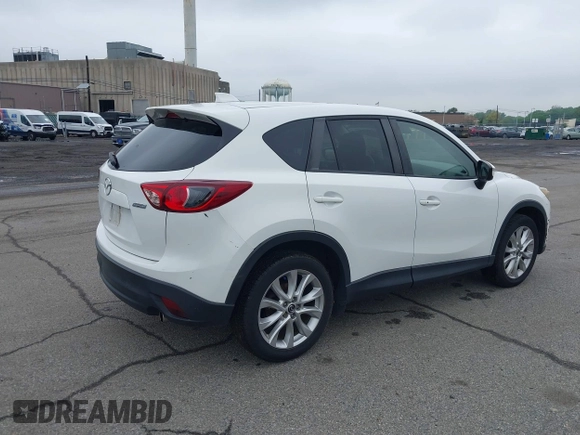 2015 Mazda CX-5 Grand Touring with VIN JM3KE4DY5F0530854, listed as a IAAI auction lot 42274582 with 144,732 mi miles and . Bid and sale history available at DreamBid. Image 4.