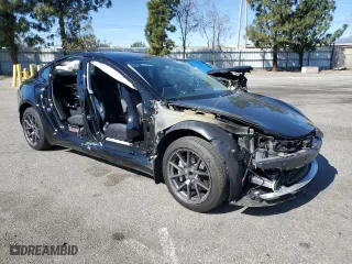 2021 Tesla Model 3 Standard Range Plus with VIN 5YJ3E1EAXMF027428, listed as a Copart auction lot 45730105 with 27,385 mi miles and Salvage Title. Bid and sale history available at carsss.com. Image 4.