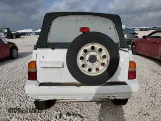 1994 Suzuki Sidekick z VIN 2S3TA01C8R6408593, wystawiony jako Copart lot #65011514 z przebiegiem 248 814 mil mil oraz Tytuł czysty. Historia ofert i sprzedaży dostępna na DreamBid. Obrazek 6.