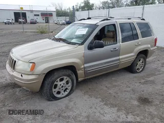 1999 Jeep Grand Cherokee Limited with VIN 1J4GW68SXXC664055, listed as a IAAI auction lot 42339125 with 219,792 mi miles and . Bid and sale history available at DreamBid. Image 2.