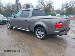 2002 Ford F-150 Harley Davidson with VIN 1FTRW07392KD29874, listed as a IAAI auction lot 41974230 with 163,279 mi miles. Bid and sale history available at carsss.com. Image 3.