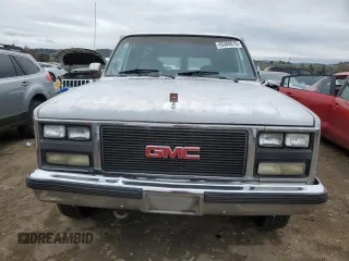 1990 GMC Suburban z VIN 1GKGR26N7LF537148, wystawiony jako Copart lot #45388815 z przebiegiem 265 951 mil mil oraz Tytuł czysty. Historia ofert i sprzedaży dostępna na DreamBid. Obrazek 5.
