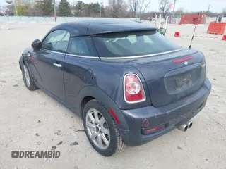 2013 MINI Coupe S with VIN WMWSX3C50DT466882, listed as a IAAI auction lot 42026938 with 99,499 mi miles and . Bid and sale history available at DreamBid. Image 3.