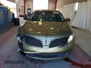 2013 Lincoln MKS EcoBoost with VIN 1LNHL9FT2DG604657, listed as a Copart auction lot 65357735 with 133,548 mi miles and Salvage title. Bid and sale history available at DreamBid. Image 5.