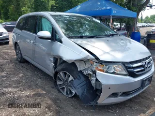 2014 Honda Odyssey Touring with VIN 5FNRL5H97EB054158, listed as a IAAI auction lot 42548360 with 91,161 mi miles and . Bid and sale history available at DreamBid. Image 1.