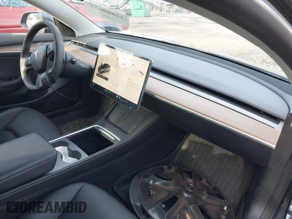 2023 Tesla Model 3 with VIN 5YJ3E1EAXPF666252, listed as a IAAI auction lot 42009929 with 27,328 mi miles and . Bid and sale history available at DreamBid. Image 5.