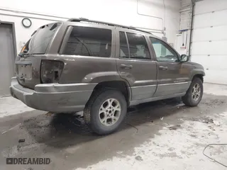1999 Jeep Grand Cherokee Laredo with VIN 1J4GW58SXXC584734, listed as a IAAI auction lot 41902224 with 209,180 mi miles. Bid and sale history available at carsss.com. Image 4.