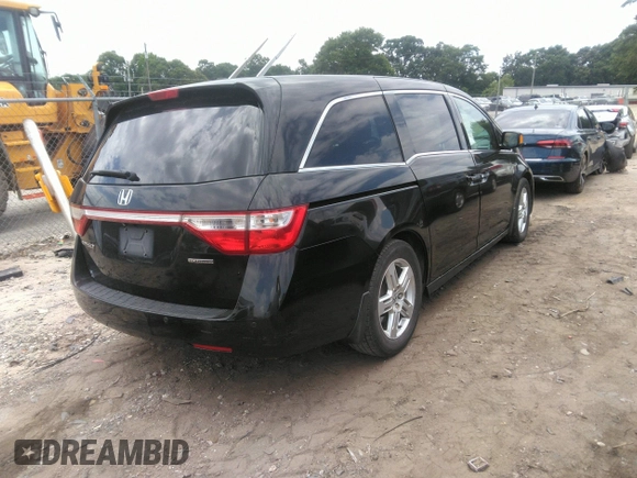 2012 Honda Odyssey Touring with VIN 5FNRL5H97CB066596, listed as a IAAI auction lot 42472935 with 217,182 mi miles and . Bid and sale history available at DreamBid. Image 4.