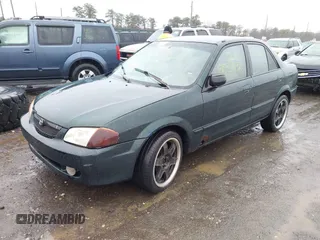 2000 Mazda Protege DX with VIN JM1BJ2225Y0255349, listed as a IAAI auction lot 41604895 with Not Provided miles and . Bid and sale history available at DreamBid. Image 2.