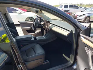 2024 Tesla Model Y with VIN 7SAYGDED3RF019063, listed as a IAAI auction lot 42061888 with 13,763 mi miles and . Bid and sale history available at DreamBid. Image 5.