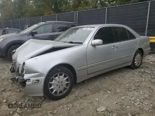 2001 Mercedes-Benz E-Class with VIN WDBJF65J71B201020, listed as a Copart auction lot 76067154 with 328,629 mi miles and Salvage Title. Bid and sale history available at carsss.com. Image 1.