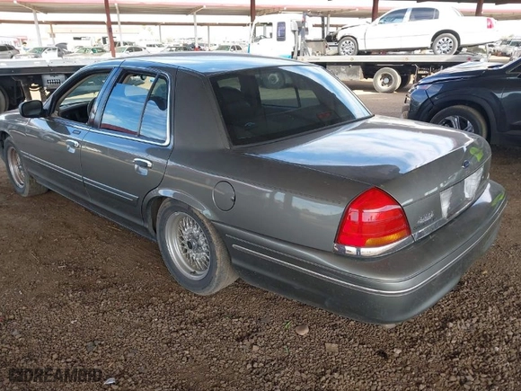 1999 Ford Crown Victoria LX with VIN 2FAFP74W9XX233325, listed as a IAAI auction lot 40934834 with 176,845 mi miles. Bid and sale history available at carsss.com. Image 3.