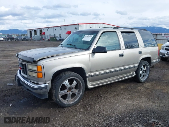 1999 GMC Yukon with VIN 1GKEK13R2XJ712390, listed as a IAAI auction lot 41793649 with 222,721 mi miles. Bid and sale history available at carsss.com. Image 2.