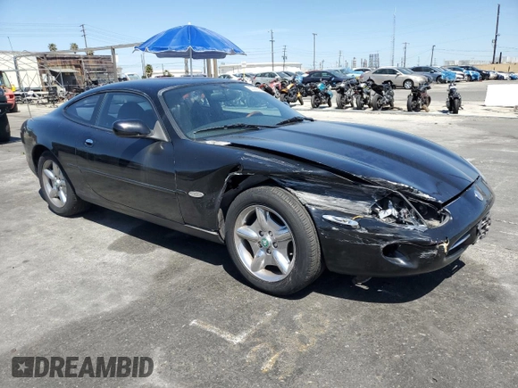 1997 Jaguar XK with VIN SAJGX5740VC014035, listed as a Copart auction lot 53066215 with 140,692 mi miles and Salvage Title. Bid and sale history available at DreamBid. Image 4.